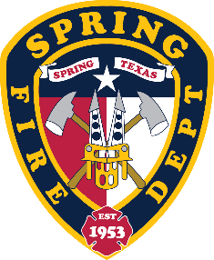 Spring Fire Department badge featuring axes, ladder, star, and the text "Spring Texas" and "Est 1953" on a shield-shaped emblem.